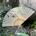 Handmade silk folding fan with swallow embroidery and green tassel on bamboo frame - Willow and Swallows