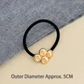 Elastic hair tie with gold metallic spherical beads and a black high-stretch cord design - Four Small Circles Gold