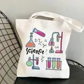 Bolsa de lona blanca con ilustraciones científicas de colores sobre silla negra - C2 Tema Ciencia Sin Bolsillo Interior Sin Cremallera