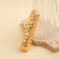 Detail of a minimalist gold metal handle with hammered texture on a stone base - Hammered Bar Hair Clip / Gold