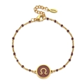 Detailed macro view of a gold stainless steel beaded bracelet with a brown zodiac charm - Stainless Steel / Scorpio-Reddish Brown
