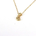 Detailed close-up of a gold-plated necklace featuring a minimalist letter G pendant - Letter G