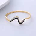 Detailed view of wave-shaped gold bangle featuring black and white rhinestone pave setting - Black White Zirconia Wave Bangle / Gold