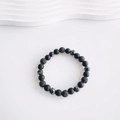 Detailed view of matte black beads and porous volcanic stone on an adjustable cord bracelet - 8mm Beads/Perimeter 18-24cm / 8mm Snowflake Obsidian