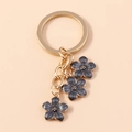 Portachiavi con fiori di ciliegio grigio scuro e anello in metallo dorato - Nero