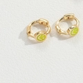 Gold star-shaped earrings featuring green smiley face pendants on textured background - Green Smiley Face / Gold