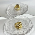 Detailed macro view of a four-layer gold-plated open ring with high-polish finish. - Gold
