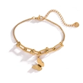Macro detail of 18K gold-plated butterfly pendant on mixed-link stainless steel bracelet - Gold