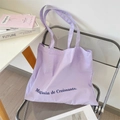 Detailed close-up of a lavender canvas tote bag with Magasin de Croissants lettering - Light Purple