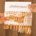 Fashion gold earring set featuring geometric hoops and faux pearl charms held by hand - KC Gold (5594)