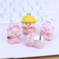 Miniature pink resin pig desk decor set with 4 cute figurines on a laptop keyboard - 002 Mini Doudou Pig Set
