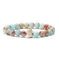 Detail of blue and brown stone beads with a white elephant charm on an elastic bracelet - Shoushan Stone