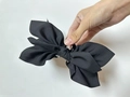 Large black fabric bow hair claw clip with multi-layered design and secure plastic grip - Black Paisley