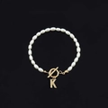 Fashion pearl bracelet featuring white oval beads, gold T-bar clasp and letter K charm - Gold Letter K (SL2013)