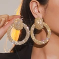 Macro detail of oversized gold-plated hoop earrings fully encrusted with white crystals - Round / Gold