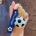 Blue football keychain with white strap, 3D sports ball pendant and gold metal hardware - Football