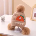 Knitted kids hat in khaki with pom-poms and cute dinosaur embroidery for winter - Triple Pompom Dinosaur Ear Flap Khaki