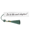 Macro shot of silver stainless steel bookmark with green tassel and engraved text detail - A13-Green Tassel Next Chapter