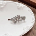 Detailed close-up of a silver magnetic hair clip with sparkling rhinestone butterflies - Double Butterfly / White