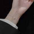 Minimalist silver beaded bracelet with a round sphere charm on woman's wrist - Silver Metal Ball Single Pendant (MY35749)