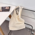 Close-up of cream popcorn crinkle texture on a large casual shoulder tote bag - Beige