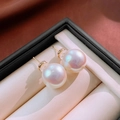 Macro shot of high-luster mermaid pink pearl earrings with golden stud backs in a box - 21# Silver Earring Post-Gold White-14mm (Large Iridescent)