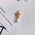 Macro detail of 18K gold crown pendant with pink stone and zircon teardrop on white card - Pink-5#