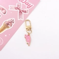 Detailed view of pink enamel cat keychain with gold lobster clasp and decorative card - Pink Cat