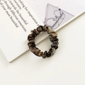 Glossy silk scrunchie in metallic brown and gold marble texture on vintage book - Mixed Metallic Tie-dye