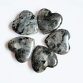 Polished grey heart-shaped natural stone carving for home decor on white background - Larvikite