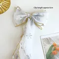 White organza bow hair clip with silver snowflakes and gold trim for girls - White Streamer Bow Hair Clip (A190-10)