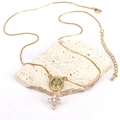 Detailed view of gold necklace with Virgin Mary medal and zircon cross on stone - Style 9