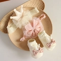Detailed close-up of baby lace headbands and matching bow socks in a ceramic dish - 4650 Beige Pink Crown Headband + Socks