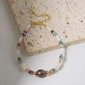 Multicolor bead bracelet with purple baroque pearl and gold accents on stone texture - Colorful Natural Freshwater Pearl Bracelet
