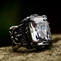 Macro shot of gothic steel ring featuring a large rectangular clear zircon and relief texture - White Gemstone