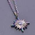 Macro shot of rainbow star pendant necklace with central white zircon and metal details - Necklace Set / Rainbow
