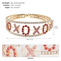 Detailed view of XOXO gold bracelet featuring sparkling red and pink rhinestones inlay - Gold