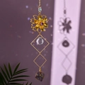 Detail of flower suncatcher with amethyst raw stone and crystal ball in sunlight - Purple Crystal