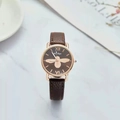 Detail of rose gold watch face with brown leather strap and bee pattern dial - Brown