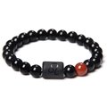Macro view of black and red stone bead bracelet featuring the Leo zodiac symbol bead - Leo