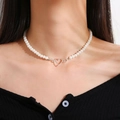 Elegant pearl necklace with a silver hollow heart pendant shown on a model neck - SY307-Silver Hollow Heart Pendant Pearl Necklace