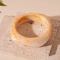 Acrylic resin bangle with orange and amber marble pattern on creamy white base - Beige Irregular Bangle