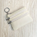 Beige faux leather coin purse with triple zippers and lychee grain texture and keyring - Off White