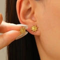 Detailed view of matte gold sunburst stud earring being held to show actual size and scale - Sun Shape (8633)
