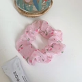 Pink organza scrunchie featuring cute red cherry patterns for a feminine hair style - Ripe Cherry Pink