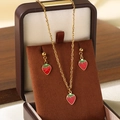 Golden strawberry pendant necklace and earrings set with red and green enamel details - Red Strawberry Jewelry Set with Box (KS225999-Z)