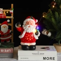 Glow Santa Claus figurine with music and LED light on a decorative book table setting - Santa Claus