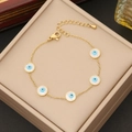 Gold evil eye jewelry set with five blue charms and adjustable lobster clasp on a beige box - Evil Eye Bracelet (2#手链)