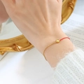 Minimalist red cord and gold titanium chain bracelet with a sparkling yellow zircon stone - November Yellow