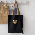 Detail einer schwarzen Canvas-Tasche mit süßem Bärenprint und khakifarbenen Griffen - Kleiner Runder Bärenkopf Schwarz